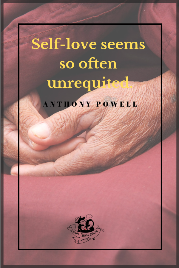 wrinkled hands of a monk with text overlay of motivational quote - Self-love seems so often unrequited - Anthony Powell