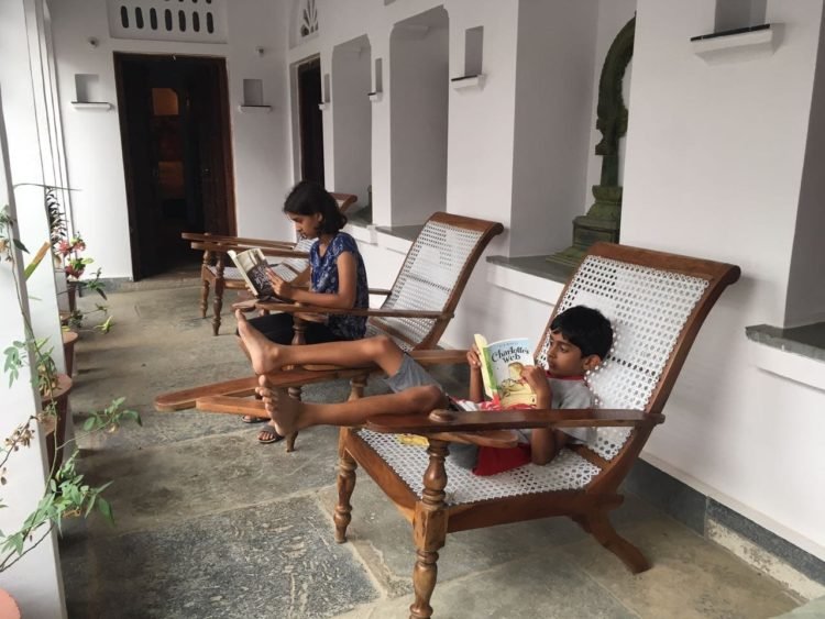 family_travel_blog_children_reading_traditional_chair