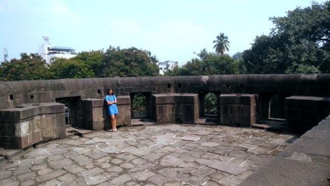 My daughter enjoys the view of shaniwar wada from one of the nine bastions in Shaniwar Wada. Built in 1732, Shaniwarwada is a historical fortification in the city of Pune in Maharashtra, India. Read more about the The former love-nest of Bajirao and Kashi and Bajirao and Mastani.