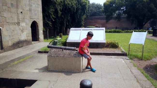 My Son resting on a Cannon mounted on a wall in the Shaniwar Wada Complex. Built in 1732, Shaniwarwada is a historical fortification in the city of Pune in Maharashtra, India. Read more about the The former love-nest of Bajirao and Kashi and Bajirao and Mastani. 