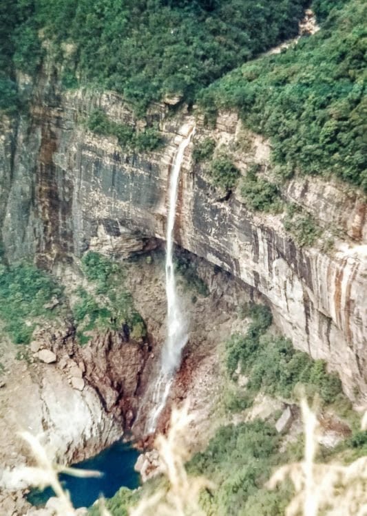 Nohkalikai Waterfall Meghalaya India Cherrapunjee, also known as Sohra, is a high-altitude town in the northeast Indian state of Meghalaya. It's known for its living root bridges, made from rubber trees. To the northeast, Mawkdok Dympep Valley View Point overlooks verdant gorges. In the surrounding hills, the Noh-Kalikai, Dain-Thlen and Kynrem waterfalls plunge from forested clifftops. South of town, Mawsmai Cave is illuminated to show its stalagmites #lighttravelaction #meghalaya #incredibleindia #offbeatindia #northeastindia