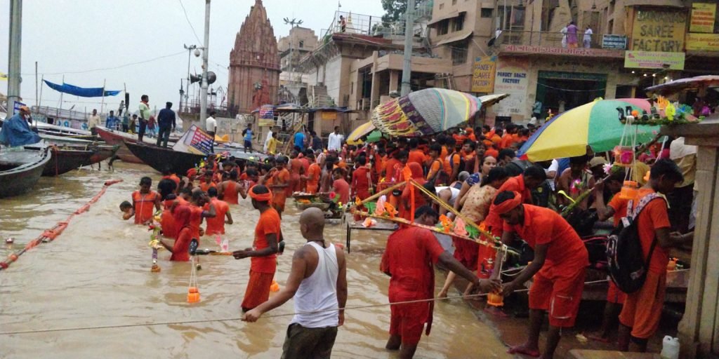 kanwariyas who are devotees of shiva can be seen bathing in safron robes in the holy water of the ganges