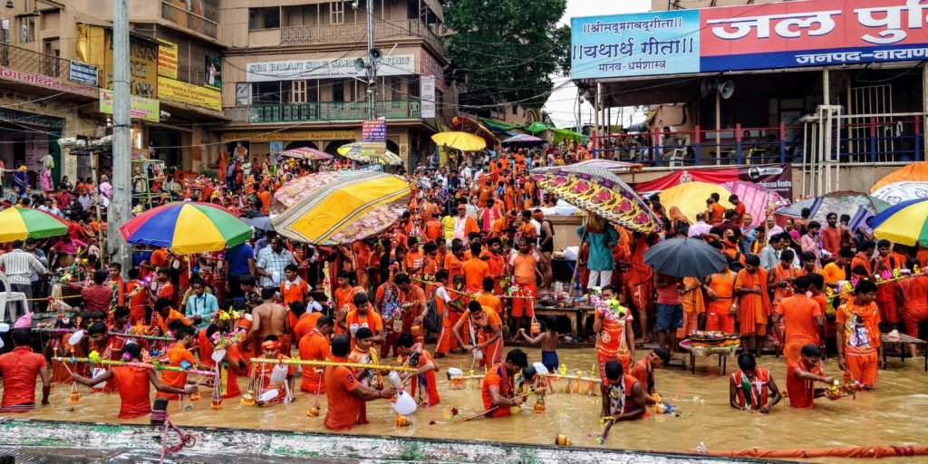 kanwariyas who are devotees of shiva can be seen bathing in safron robes in the holy water of the ganges