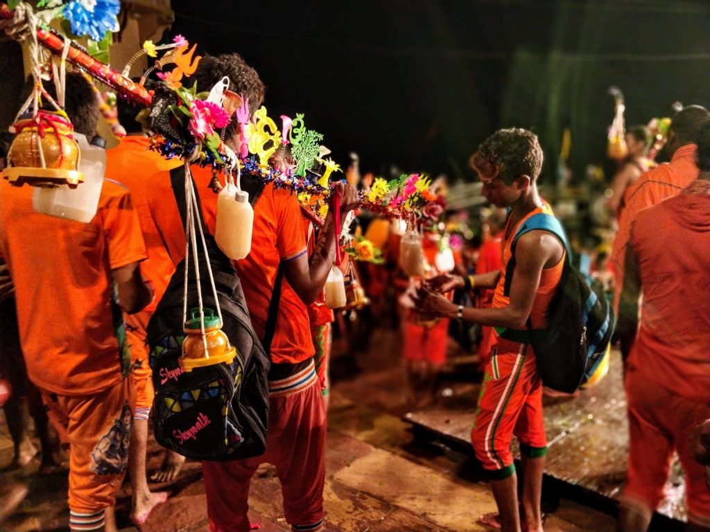 kanwariyas who are devotees of shiva can be seen bathing in safron robes in the holy water of the ganges