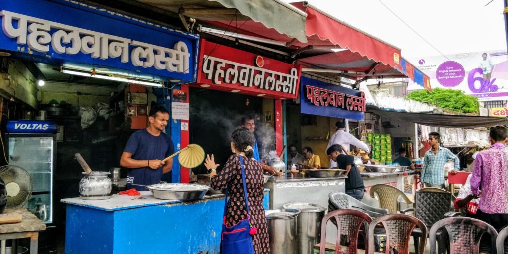 Woman buying lassi at the Pehalwan lassi bhandar in lanka in varanai in uttar pradesh india