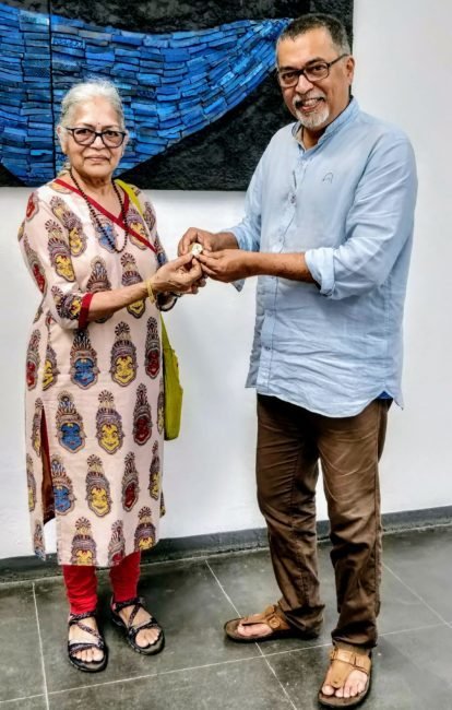 My Mother receiving a gift from Dr Subodh Kerkar inside the Kerkar Musuem of Goa in Goa, India