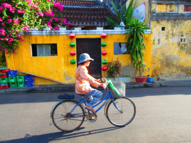 water sketch of a Vietnamese woman on cycle