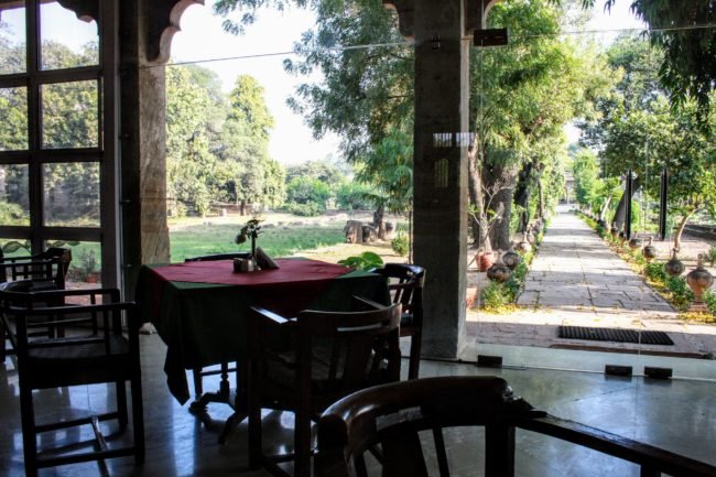 Table and chairs laid our in the dinning area of Neemrana's Deo Bagh Heritage Hotel Gwalior