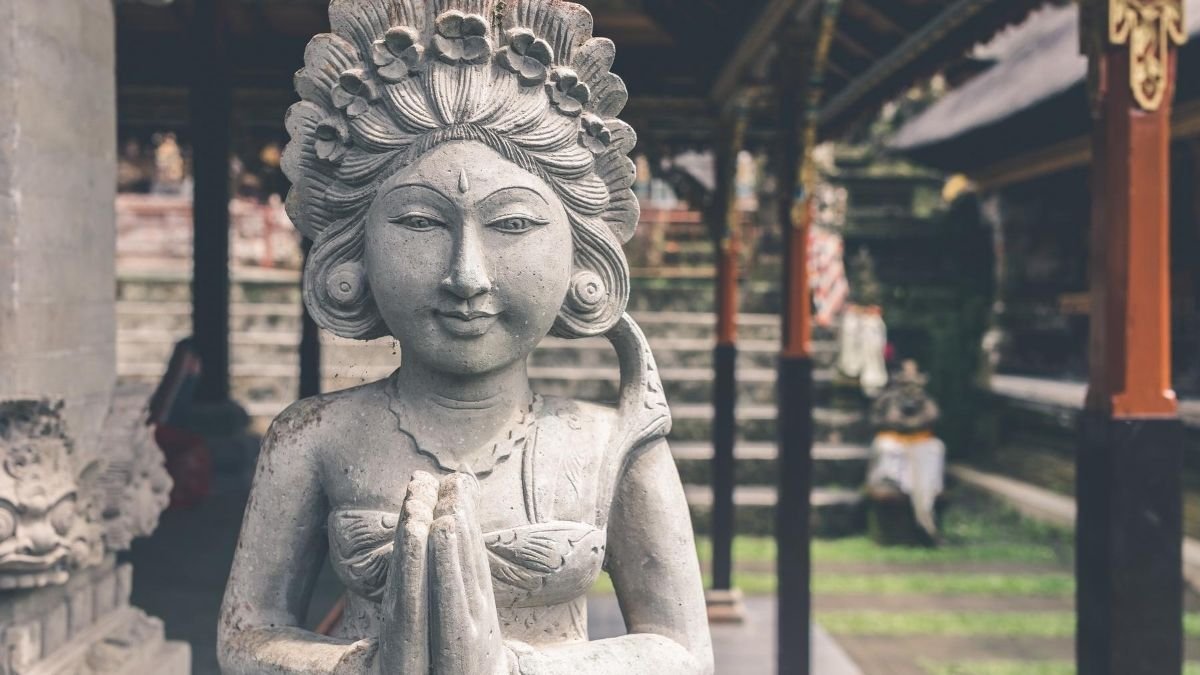 A statue in Namaste pose